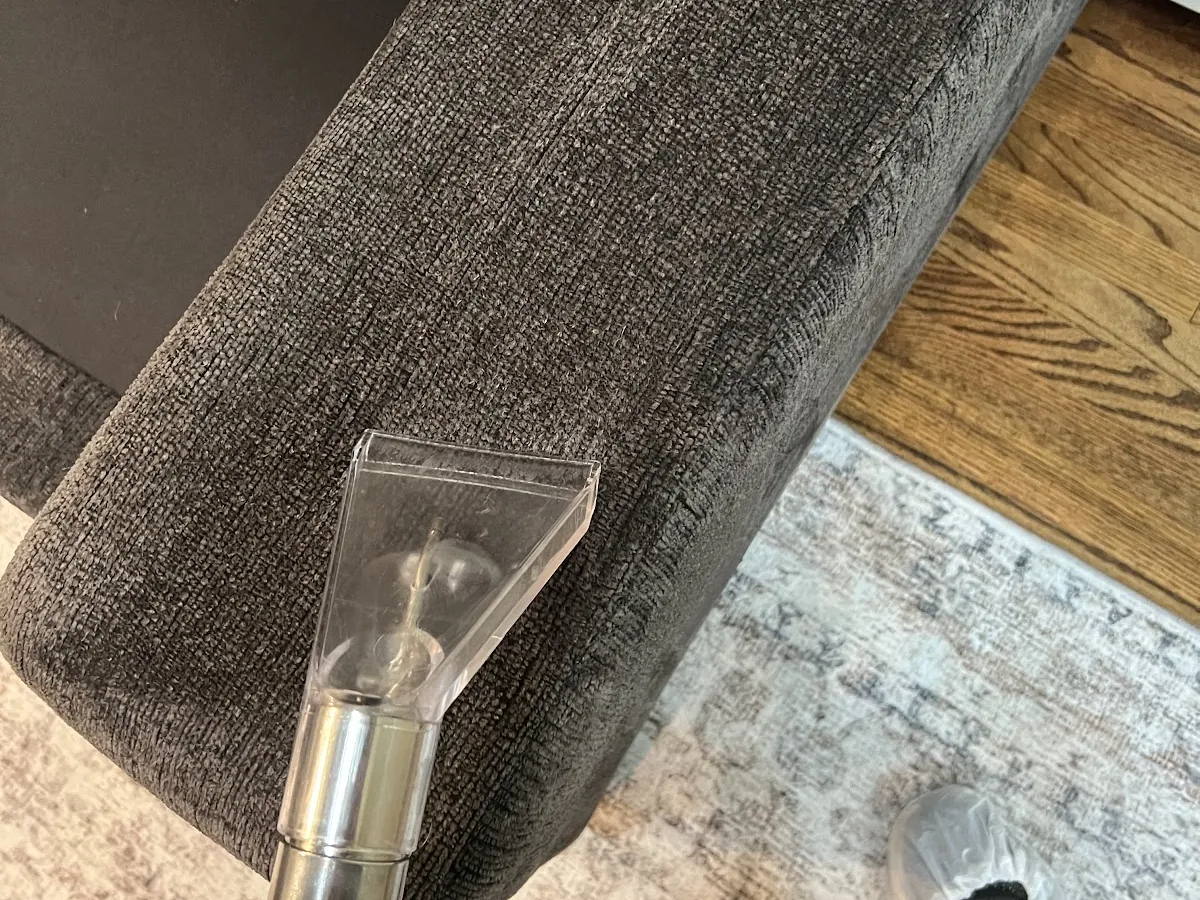 Upholstery tool extracting a sofa arm during cleaning