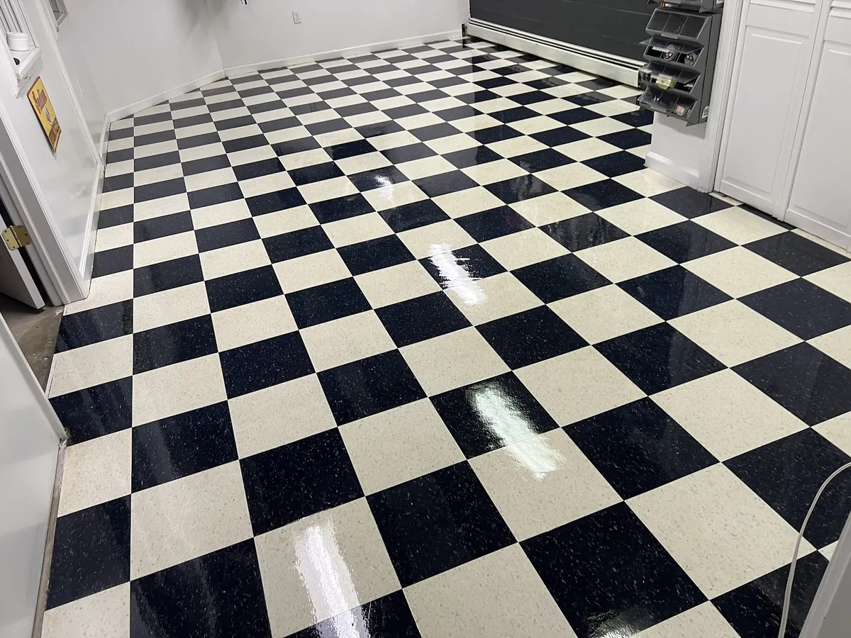 Freshly stripped and waxed black-and-white VCT floor in a commercial building